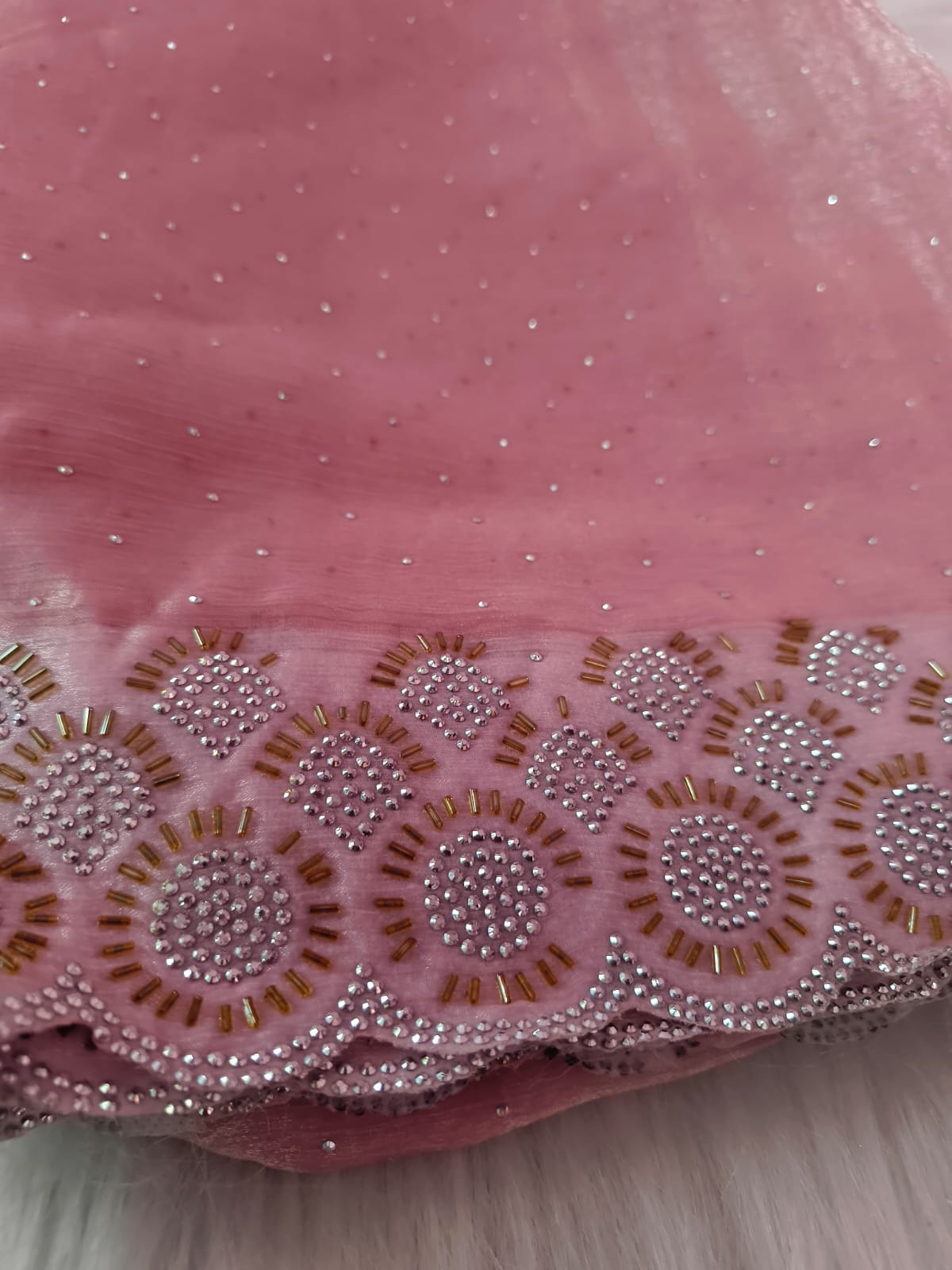 Close-up of the scalloped border with round stone medallions and gold-tone bugle beads on pink space silk