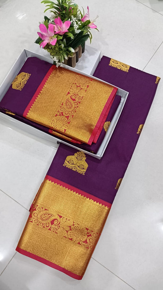 A purple and gold silk saree with red borders.