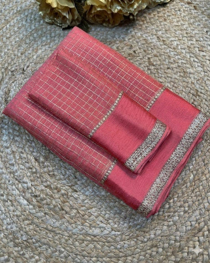 Red fabric with silver embroidery on a textured surface