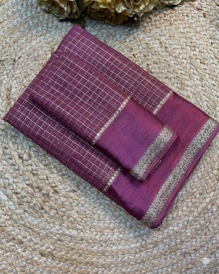 Purple fabric with grid pattern and silver border on a textured beige surface