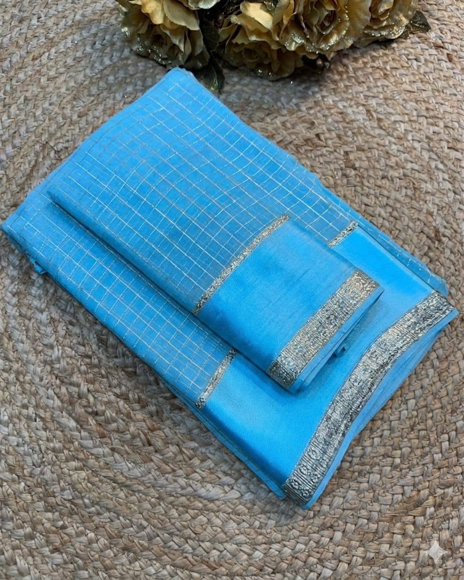 Blue fabric with silver border on a textured surface