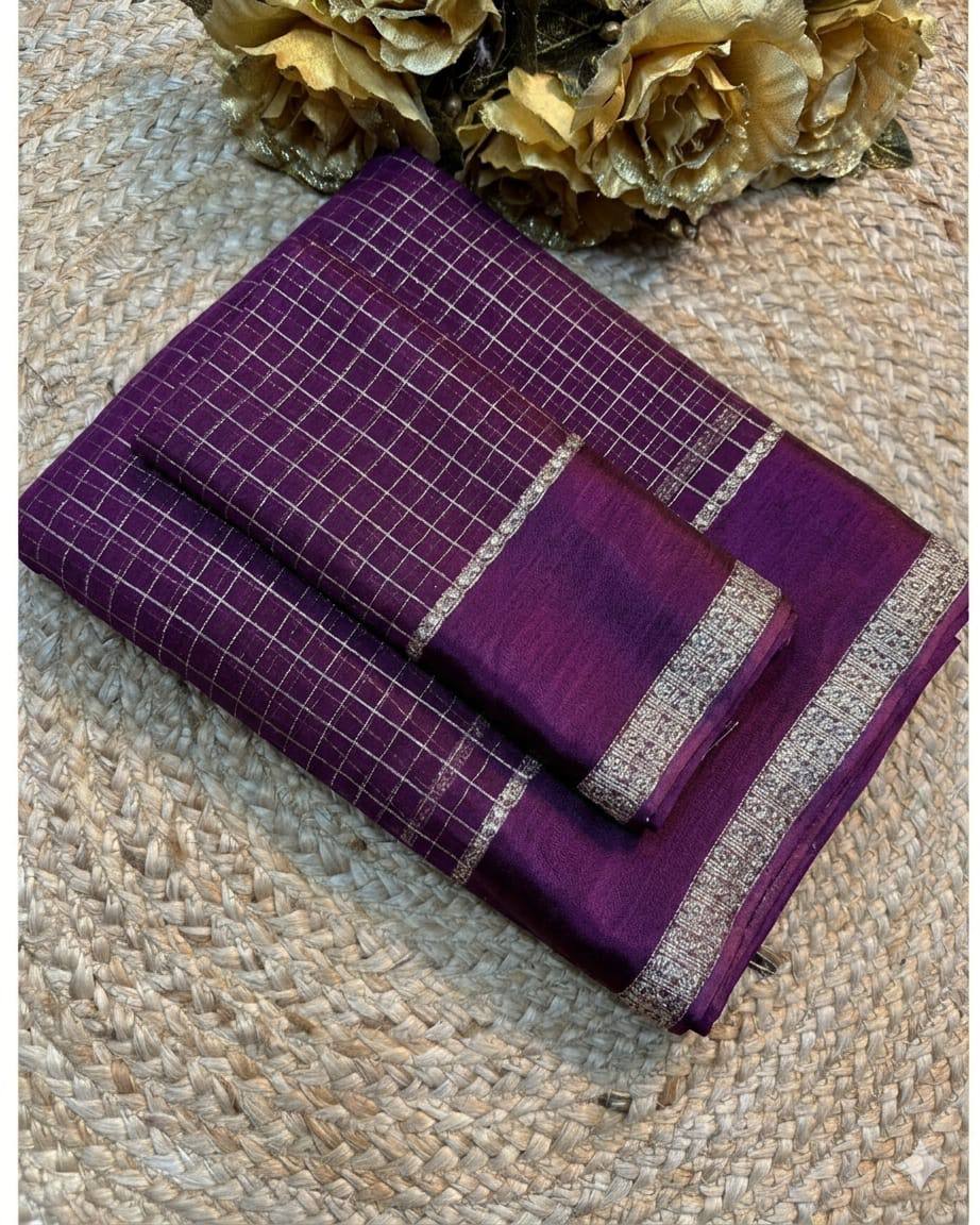 Purple fabric with silver border on a textured surface