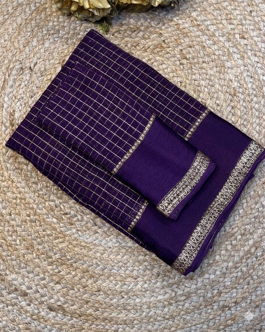 Purple fabric with silver embroidery on a textured surface