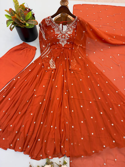 Rust orange sequin embroidered Anarkali gown, pants and dupatta set laid flat