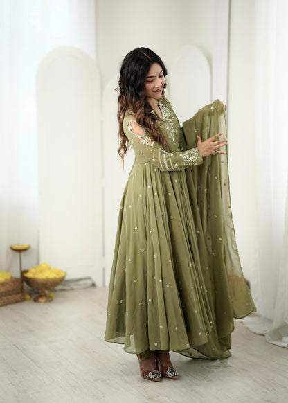 Side view of mehendi green embroidered Anarkali gown with dupatta held in hand