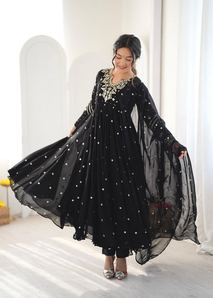 Black sequin embroidered Anarkali gown with dupatta flared out while twirling