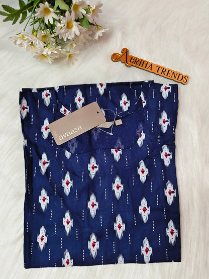 A folded navy blue kurta with a white and red ikat pattern and a decorative wooden 'ABRIHA TRENDS' sign on a white faux fur background with white daisies.