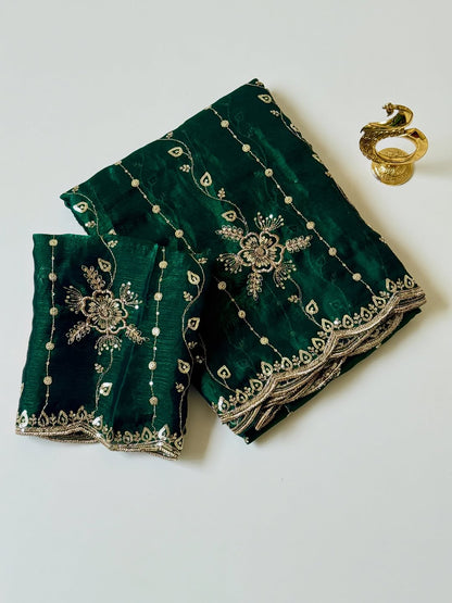 Bottle green Fendy chiffon saree with gold sequin embroidery and scalloped border, folded with blouse piece
