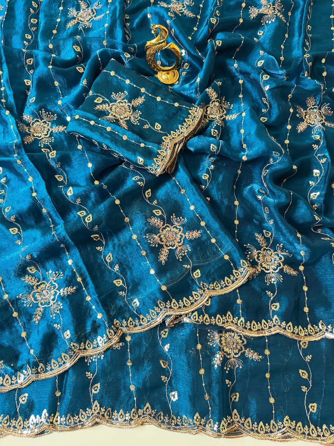 Peacock blue Fendy chiffon saree spread out showing all-over floral sequin embroidery