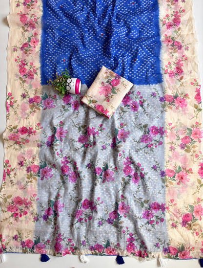 Royal blue linen cotton saree spread out showing grey-blue floral pallu with mirror work and blue and white tassels