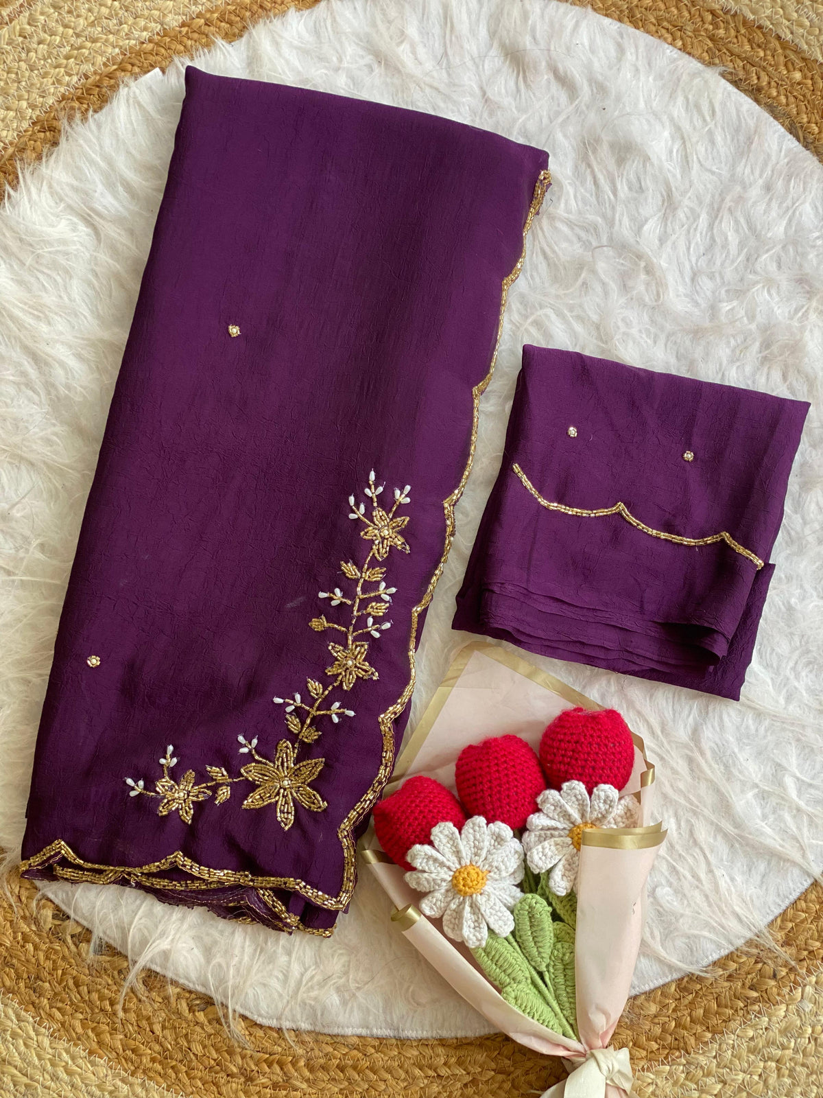 Purple crush silk saree folded with blouse piece, gold bead and pearl floral handwork on the pallu and scalloped bead border
