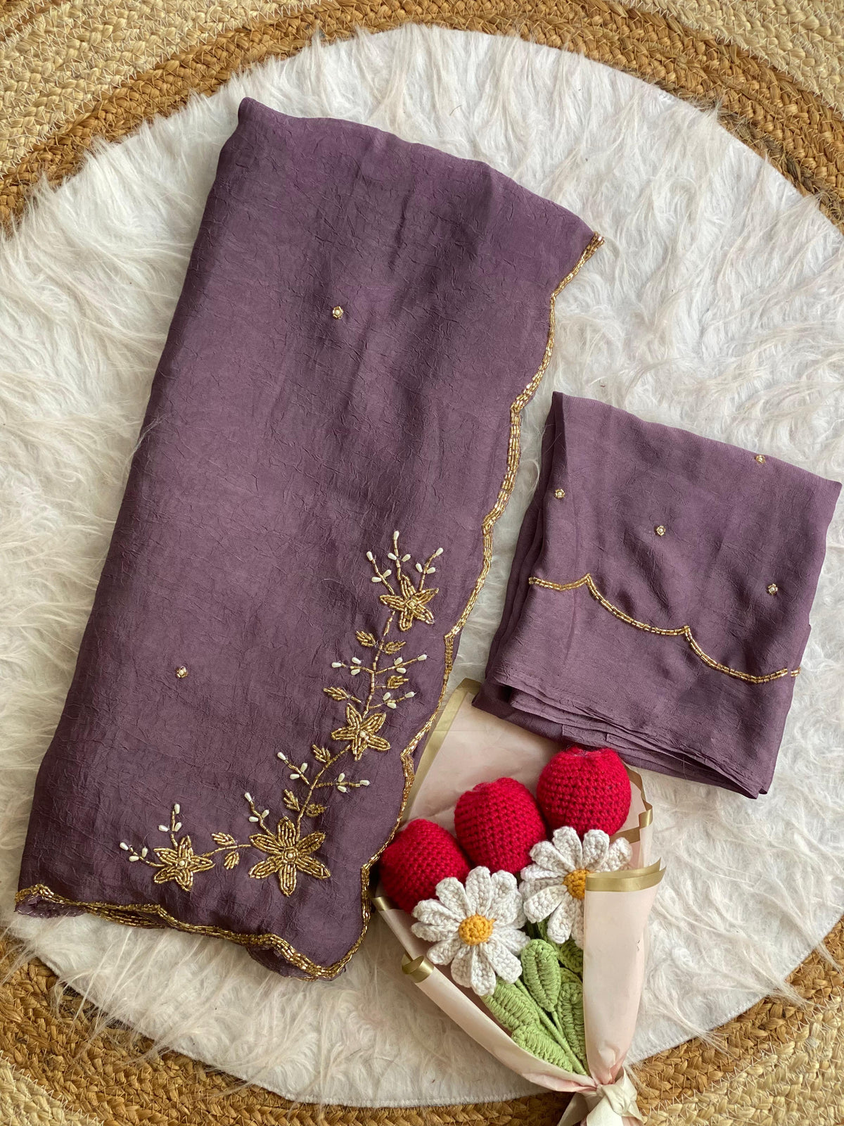 Mauve crush silk saree folded with blouse piece, gold bead and pearl floral handwork on the pallu and scalloped bead border