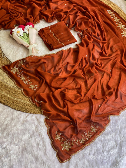 Rust crush silk saree spread out showing butta pallu, scattered bead buttis and scalloped gold bead border