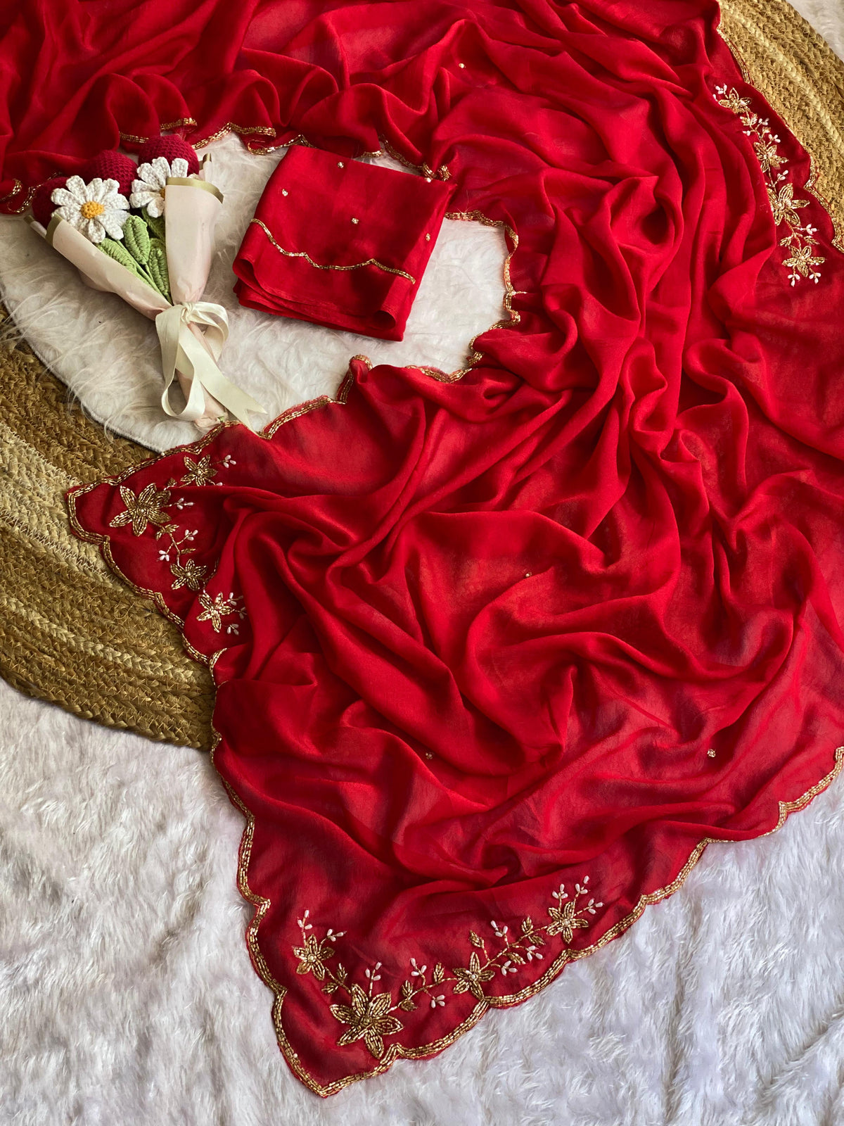 Red crush silk saree spread out showing butta pallu, scattered bead buttis and scalloped gold bead border