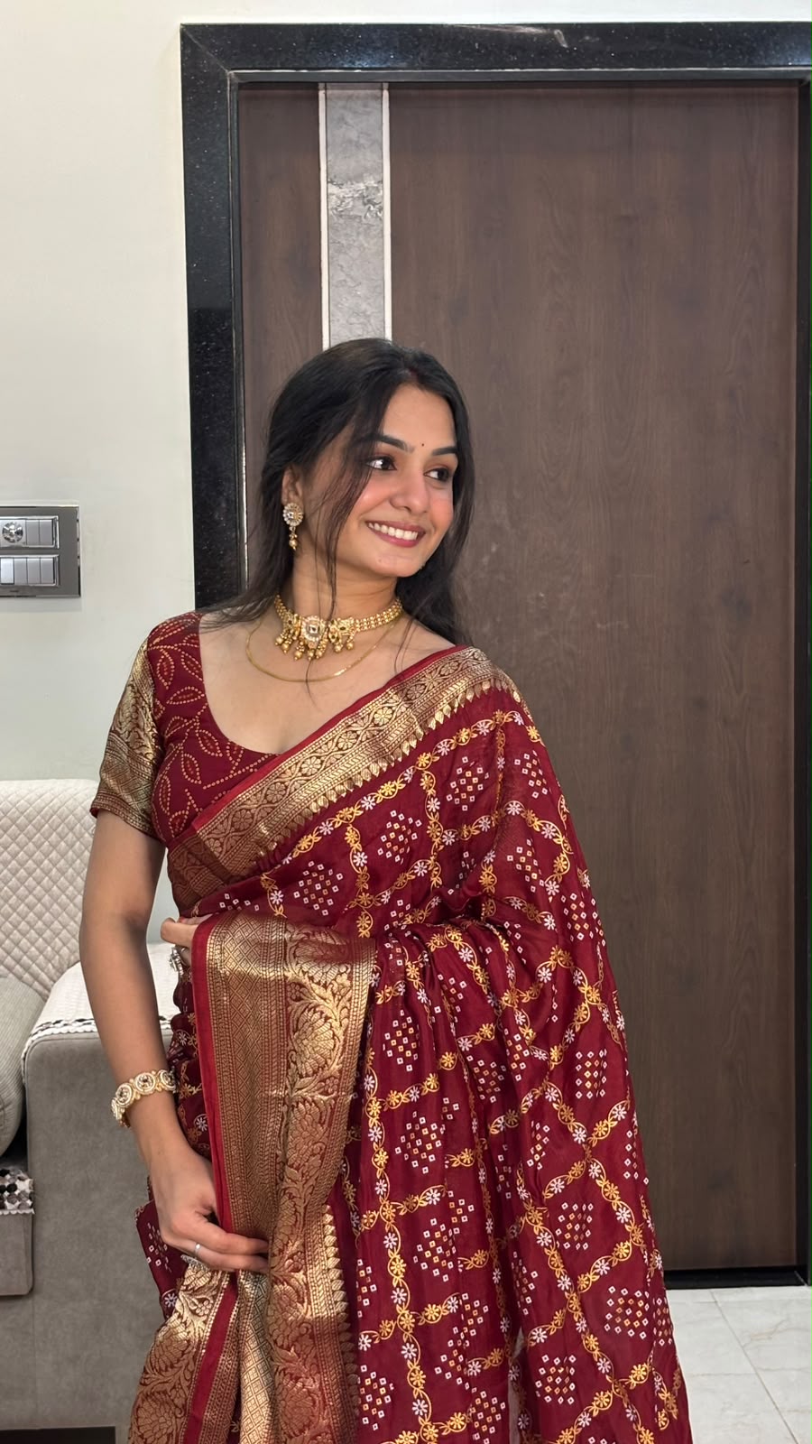Close-up of maroon bandhani dots and yellow floral jaal with zari border