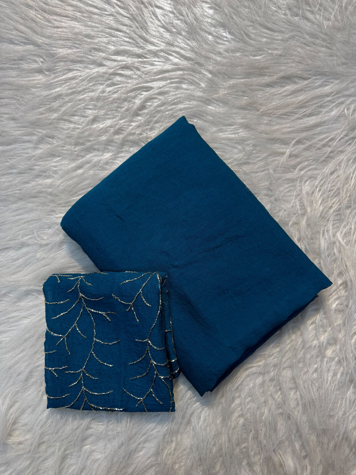 Teal blue plain Rangoli viscose georgette saree with embroidered blouse featuring metallic branch motif