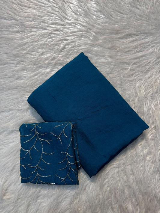 Teal blue plain Rangoli viscose georgette saree with embroidered blouse featuring metallic branch motif