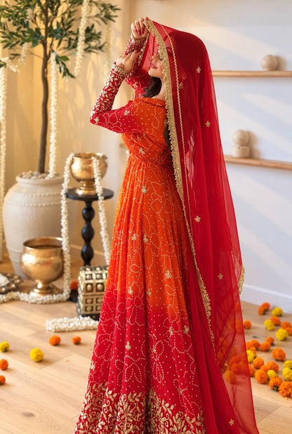 Orange red ombre bandhani print Anarkali with red lace border dupatta worn as a veil
