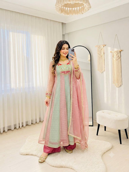 Full-length pink and mint Anarkali gown with embroidered cuffs and dupatta over shoulder