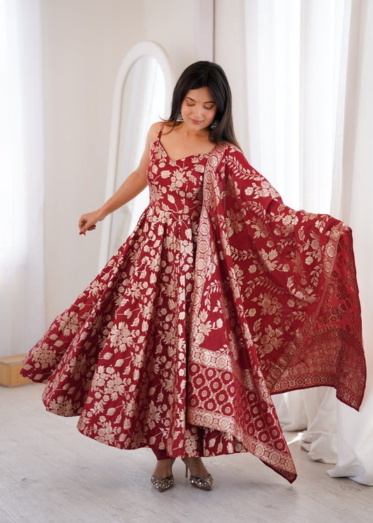 Model in maroon Banarasi jacquard dola silk Anarkali gown with gold floral weave and dupatta over the shoulder