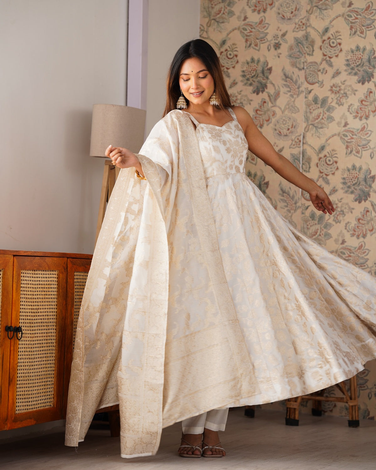 Model in ivory Banarasi jacquard dola silk Anarkali gown with gold floral weave and long dupatta