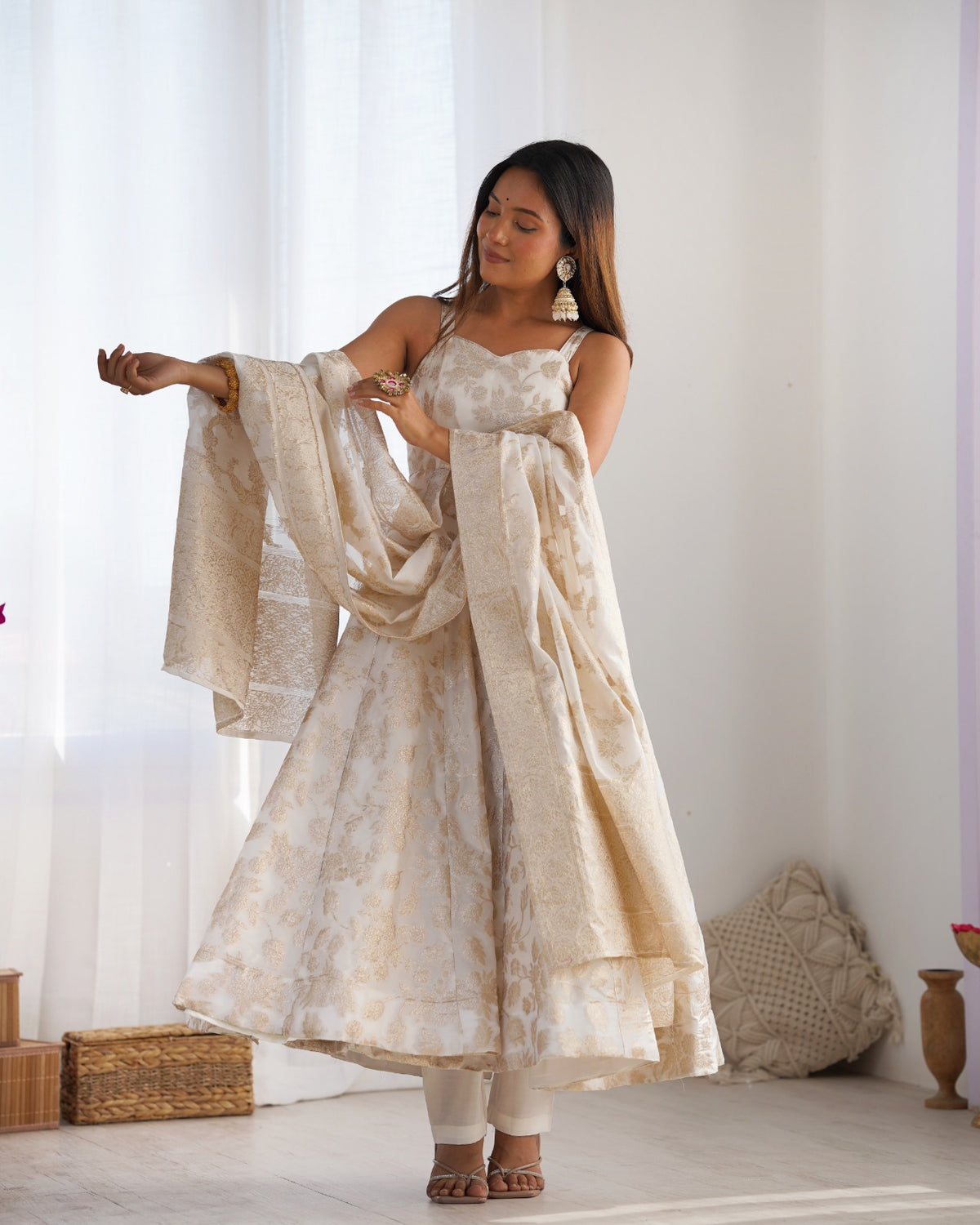 Ivory jacquard dupatta draped over the arm with sweetheart neck Anarkali gown