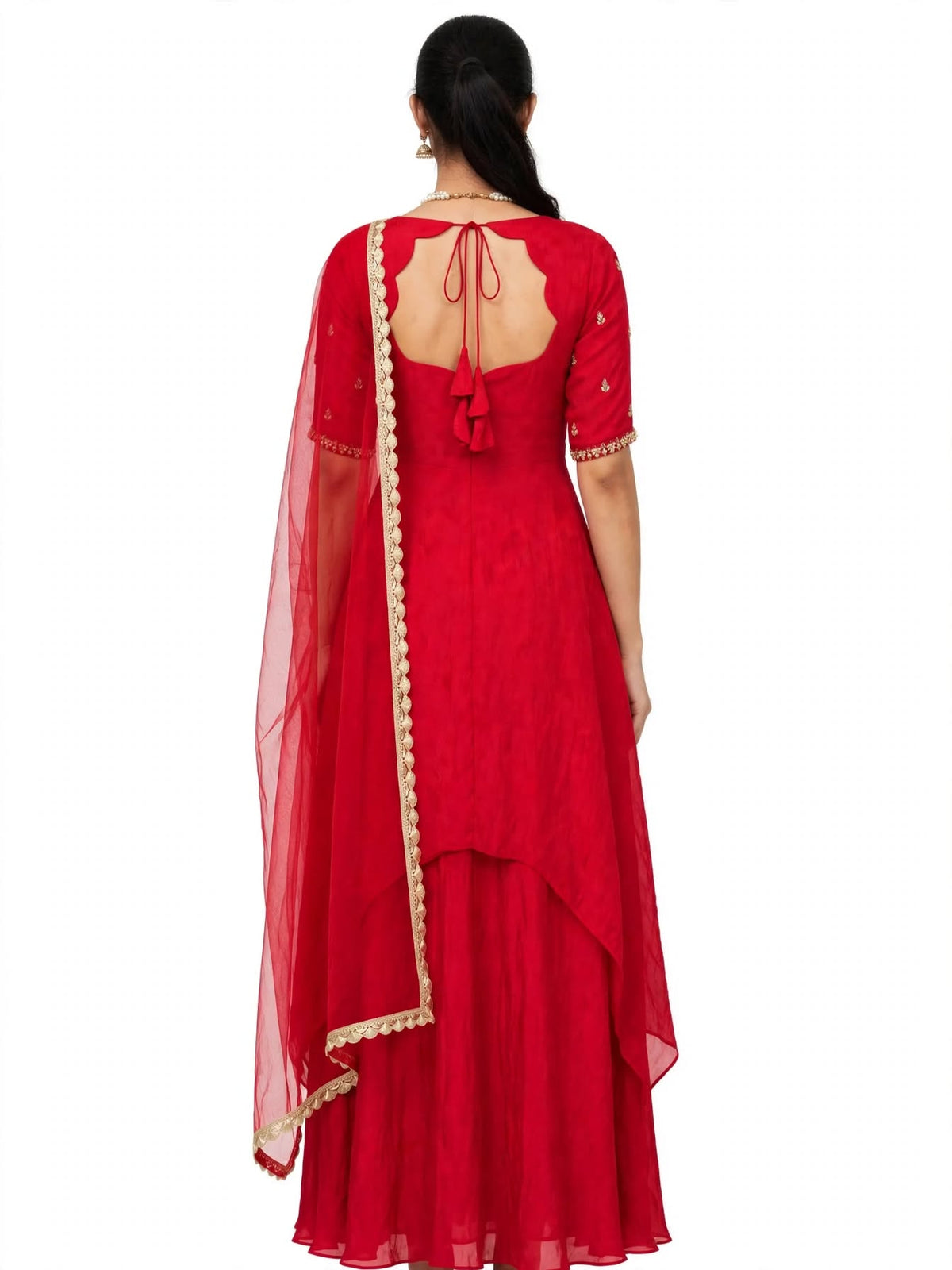 Back view of red Anarkali gown with scalloped keyhole opening, dori tie and tassels