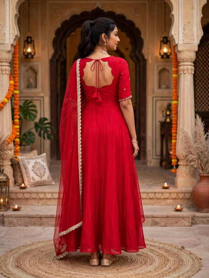 Back view of model in red Anarkali gown with tie-up back and lace-edged dupatta