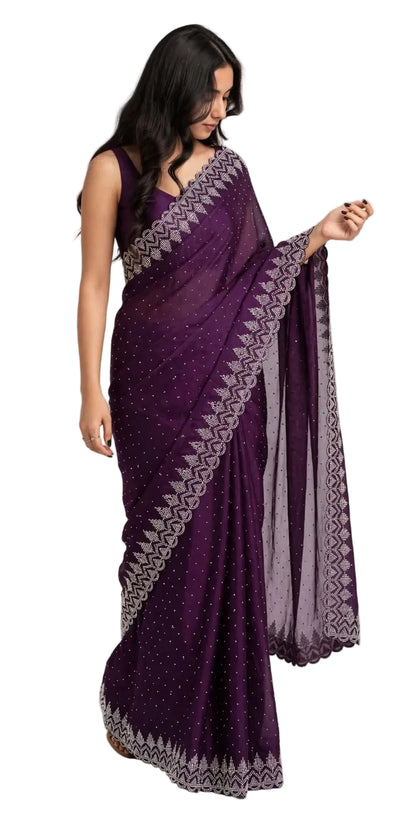Model walking in the purple stone work saree, holding the sheer pallu with its scalloped cutwork border