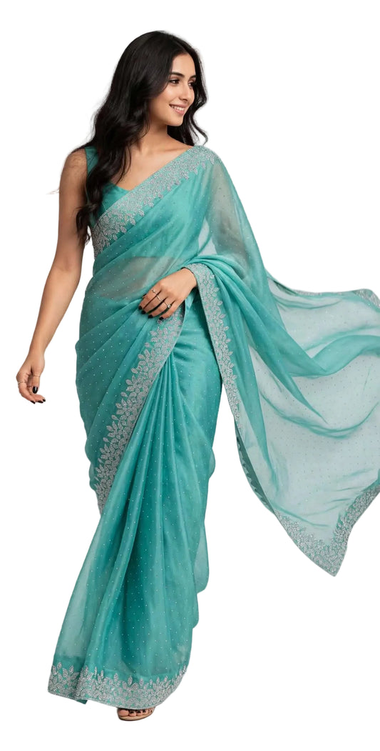 Model walking in the teal stone work saree with the flowing pallu showing scattered stones and leaf border