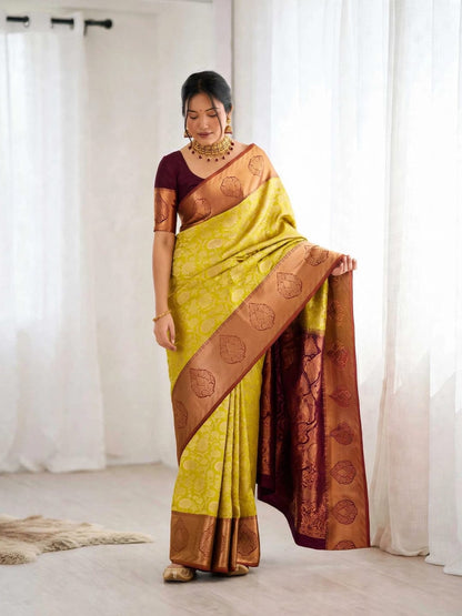 Woman wearing yellow Kanjeevaram soft silk saree with wine blouse and zari border