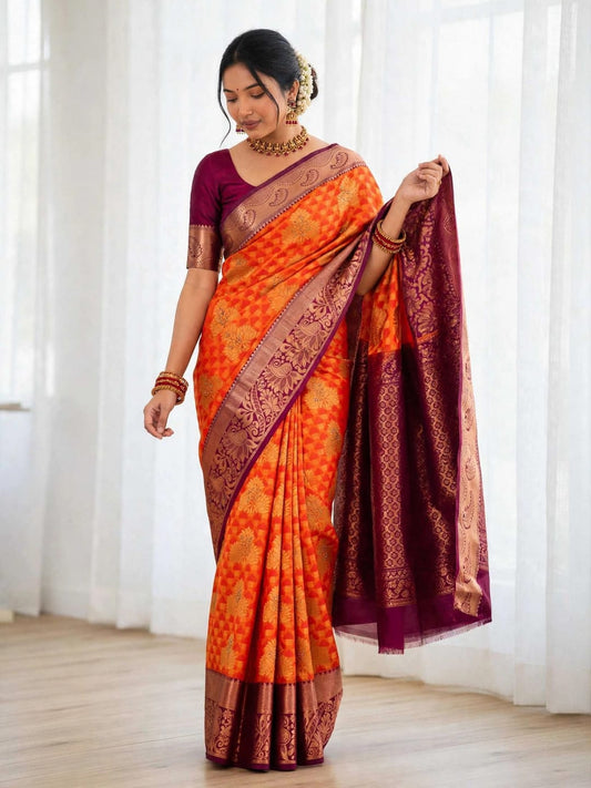 Woman wearing red-orange soft silk saree with magenta blouse and zari pallu