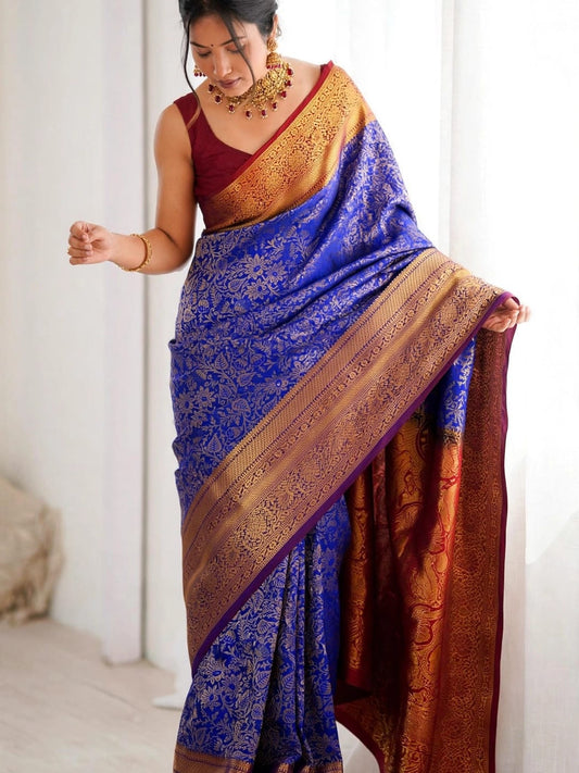 Woman wearing royal blue soft silk saree with maroon blouse and zari border